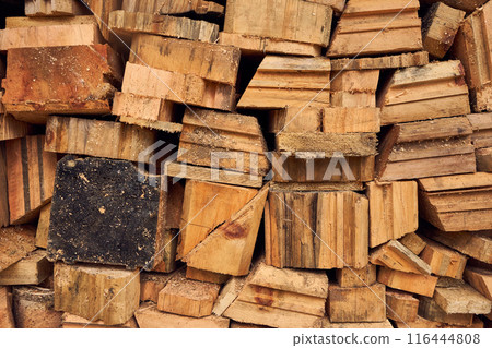 Cuttings of boards, timber. Wooden cuts different shapes and sizes. Yellow brown construction background. Sawmill work Cuttings of boards, timber. Wooden cuts different shapes and sizes. Yellow brown construction background. Sawmill work 116444808