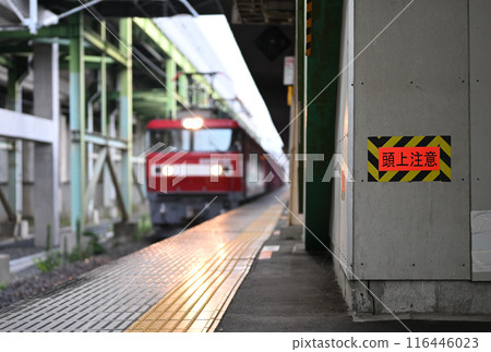 Overhead warning sign and a platform where an electric locomotive passes Overhead warning sign and a platform where an electric locomotive passes 116446023