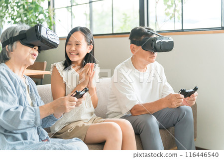 Grandparents and granddaughter experience the virtual reality metaverse with VR goggles 116446540