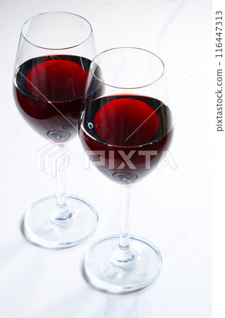 Image of two wine glasses filled with red wine making a toast Image of two wine glasses filled with red wine making a toast 116447313