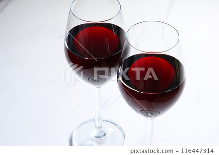 Image of two wine glasses filled with red wine making a toast Image of two wine glasses filled with red wine making a toast 116447314