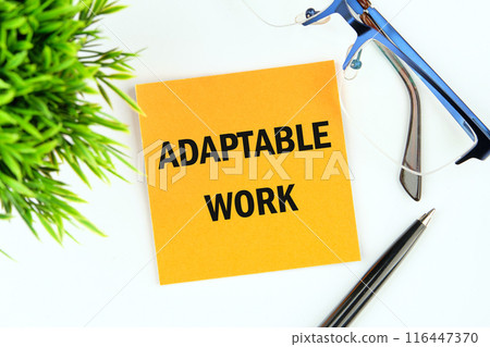 Business ADAPTABLE WORK concept. Copy space. Concept words ADAPTABLE WORK on a yellow mustard flower sticker on a white background Business ADAPTABLE WORK concept. Copy space. Concept words ADAPTABLE WORK on a yellow mustard flower sticker on a white background 116447370