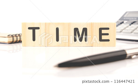 Time Word. Text on Block. Concept word TIME on wooden cubes in a composition with a calculator, a pen and a fragment of a notebook 116447421