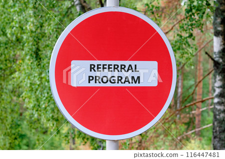 Business concept. Words REFERRAL PROGRAM on the sign entry is prohibited against the background of the forest 116447481