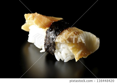 Conger eel sushi photographed against a black background Conger eel sushi photographed against a black background 116448420