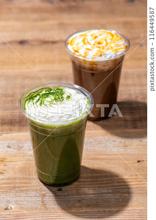 Caramel frappe and matcha frappe in plastic cups on wooden table Caramel frappe and matcha frappe in plastic cups on wooden table 116449587