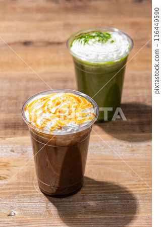 Caramel frappe and matcha frappe in plastic cups on wooden table Caramel frappe and matcha frappe in plastic cups on wooden table 116449590