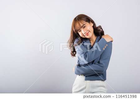 Happy beautiful young smiling Asian businesswoman hugging herself remember moment studio short isolated on white background, Self care and self esteem concept, Lifestyle female love yourself carefree 116451398