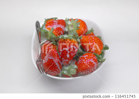 Delicious strawberries covered in condensed milk 116451745