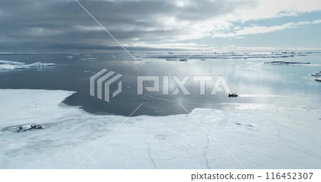 People travel Antarctica shore ride zodiac boat. Frozen polar ocean ice coast. Arctic snow covered landscape. Explore South Pole wild winter nature. Tourism, travel, expedition. Aerial drone panorama People travel Antarctica shore ride zodiac boat. Frozen polar ocean ice coast. Arctic snow covered landscape. Explore South Pole wild winter nature. Tourism, travel, expedition. Aerial drone panorama 116452307