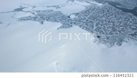 Aerial view winter frozen ocean coast landscape in Antarctica. Fly over untouched wilderness of Antarctic coastline, snow covered ice hills. South Pole travel and exploration, wild nature wallpaper Aerial view winter frozen ocean coast landscape in Antarctica. Fly over untouched wilderness of Antarctic coastline, snow covered ice hills. South Pole travel and exploration, wild nature wallpaper 116452321