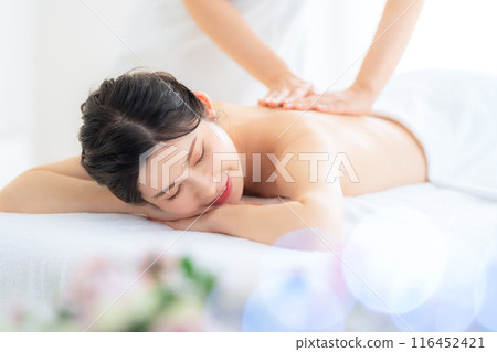 A middle-aged woman doing skin care at a beauty salon A middle-aged woman doing skin care at a beauty salon 116452421