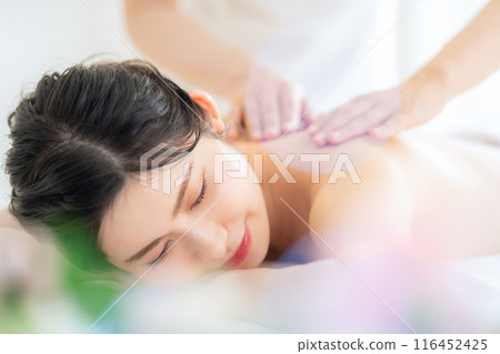 A middle-aged woman doing skin care at a beauty salon A middle-aged woman doing skin care at a beauty salon 116452425
