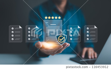 Businessman holding standard quality control certification assurance guarantee for automation process. Quality management with Quality Assurance, Quality Control, Standardization, health insurance, 116453912