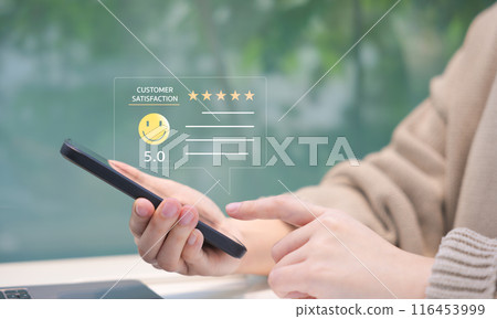Customer review satisfaction feedback survey concept. Person giving a five-star customer satisfaction rating on a smartphone, implying excellent service quality. User experience online application. 116453999