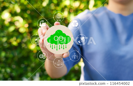 Carbon footprint concept. Carbon emissions, net zero carbon neutral. Woman holding carbon reduction icon. CO2 neutrality, Sustainable, Climate change, Global warming, Greenhouse gas, Renewable energy, Carbon footprint concept. Carbon emissions, net zero carbon neutral. Woman holding carbon reduction icon. CO2 neutrality, Sustainable, Climate change, Global warming, Greenhouse gas, Renewable energy, 116454002