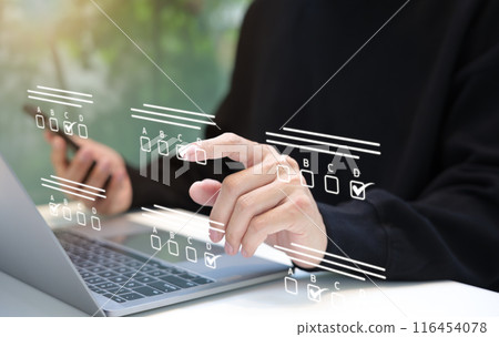 Businessman makes selections on a digital checklist. assessment online, choose correct answer in test, questions test, online exam, quiz knowledge, task management, filling out survey form. e-learning Businessman makes selections on a digital checklist. assessment online, choose correct answer in test, questions test, online exam, quiz knowledge, task management, filling out survey form. e-learning 116454078