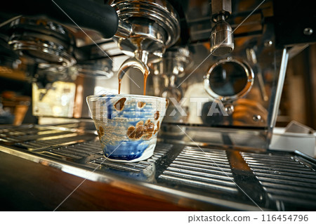 Close up of coffee machine pouring espresso in cafe 116454796