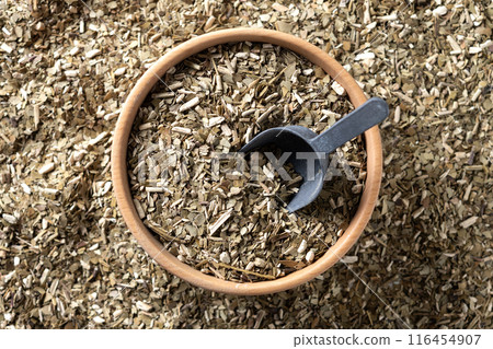 Traditional yerba mate in wooden bowl on wooden table 116454907