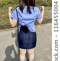A female police officer pumps her fist in the air. 116455004