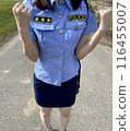 A female police officer pumps her fist in the air. 116455007