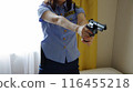Female police officer holding a pistol 116455218