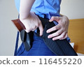 Female police officer pulling out a gun 116455220