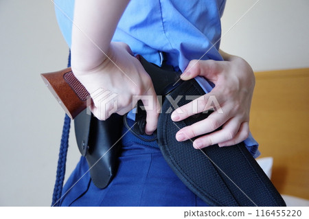 Female police officer pulling out a gun Female police officer pulling out a gun 116455220