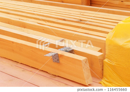 Construction of a wooden structure. Storage of new wooden planks. Wooden planks on construction site. Construction of a wooden structure. Storage of new wooden planks. Wooden planks on construction site. 116455660