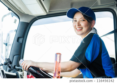 Young female driver driving a large truck Young female driver driving a large truck 116456142