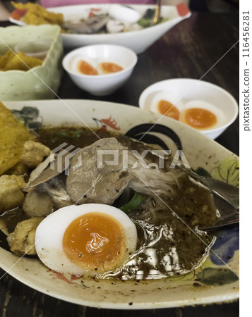 Hot and spicy Thai noodle soup with soft boiled egg 116456281