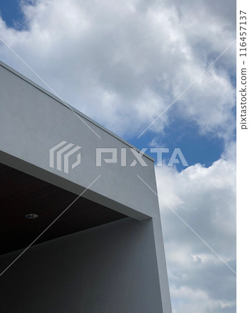 Modern architecture meeting a cloudy sky 116457137