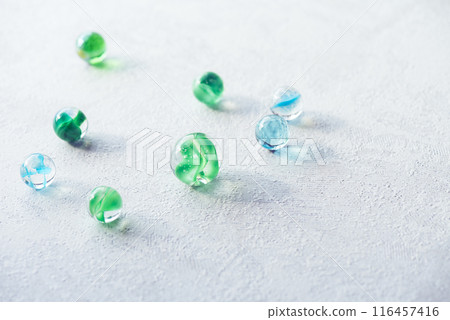 Light and shadow of green and light blue marbles 116457416