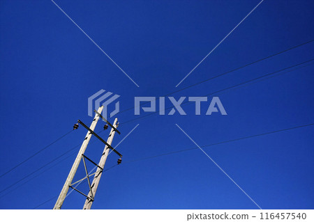 Power Lines Against Clear Blue Sky 116457540