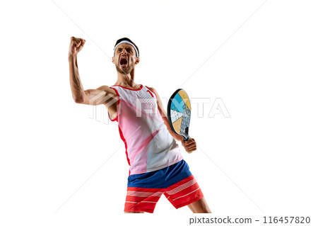 Champion. Young man, tennis player in uniform with colorful padel racket showing his motivation and ambitions, winning emotions isolated on white background Champion. Young man, tennis player in uniform with colorful padel racket showing his motivation and ambitions, winning emotions isolated on white background 116457820