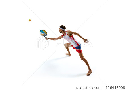 Dynamic image of young man, beach tennis player showing his motivation for victory, playing with intensity, isolated on white background Dynamic image of young man, beach tennis player showing his motivation for victory, playing with intensity, isolated on white background 116457908