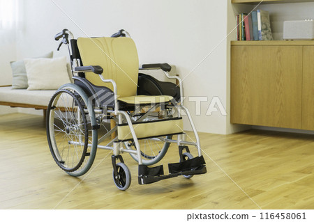 A wheelchair in a living room with bright windows A wheelchair in a living room with bright windows 116458061