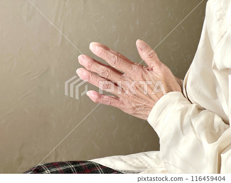 Elderly woman praying with hands together 116459404