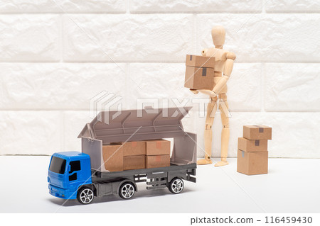 A mannequin loading luggage into a truck by hand 116459430