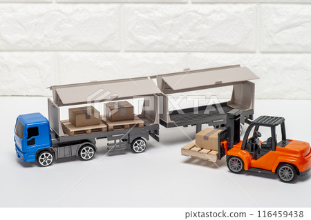 Loading cargo onto truck with forklift Loading cargo onto truck with forklift 116459438
