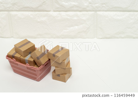 A shopping basket full of cardboard boxes of goods 116459449