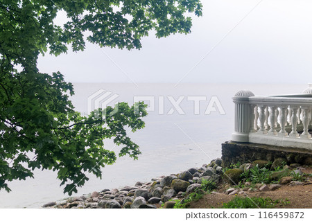 vintage white balustrade on a stone wall on the sea shore 116459872