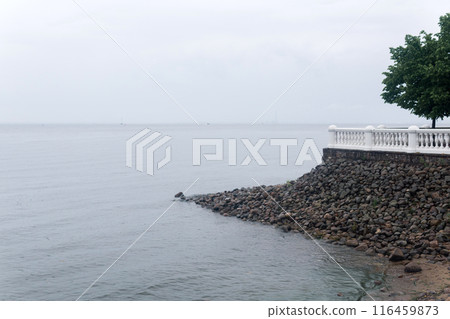 vintage white balustrade on a stone wall on the sea shore 116459873