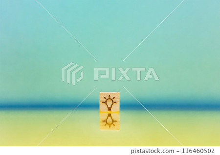 A blue background with a light bulb symbol block reflected on a yellow water surface A blue background with a light bulb symbol block reflected on a yellow water surface 116460502