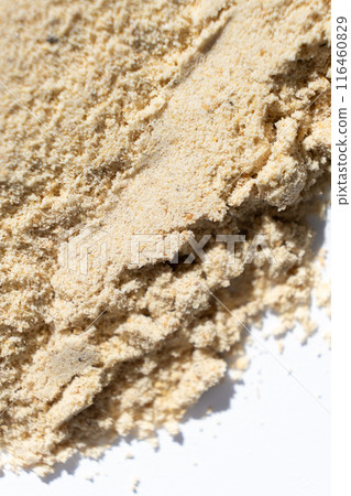 Macro spilled ginger powder, ground ginger root on a white background. 116460829