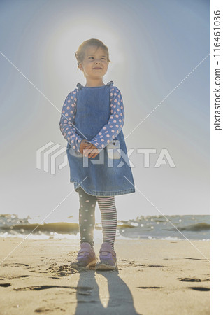 Charming child playing on the beach in Denmark Charming child playing on the beach in Denmark 116461036