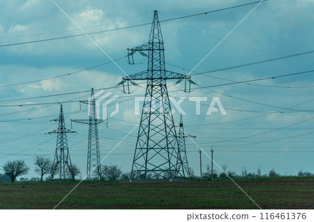 High voltage towers with sky background. Power line support with wires for electricity transmission. High voltage grid tower with wire cable at distribution station. Energy industry, energy saving 116461376