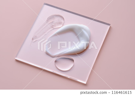 Textures of different cosmetic products on a pink background on a square transparent stand. Textures of different cosmetic products on a pink background on a square transparent stand. 116461615