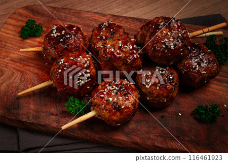 Tsukune, Japanese meatballs, minced chicken, fried on a skewer, with yakitori sauce, homemade,  116461923