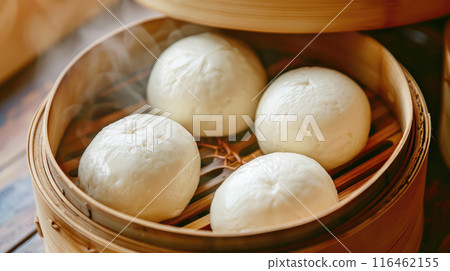 Chinese traditional steamed custard buns close up in bamboo steamer. Chinese traditional steamed custard buns close up in bamboo steamer. 116462155